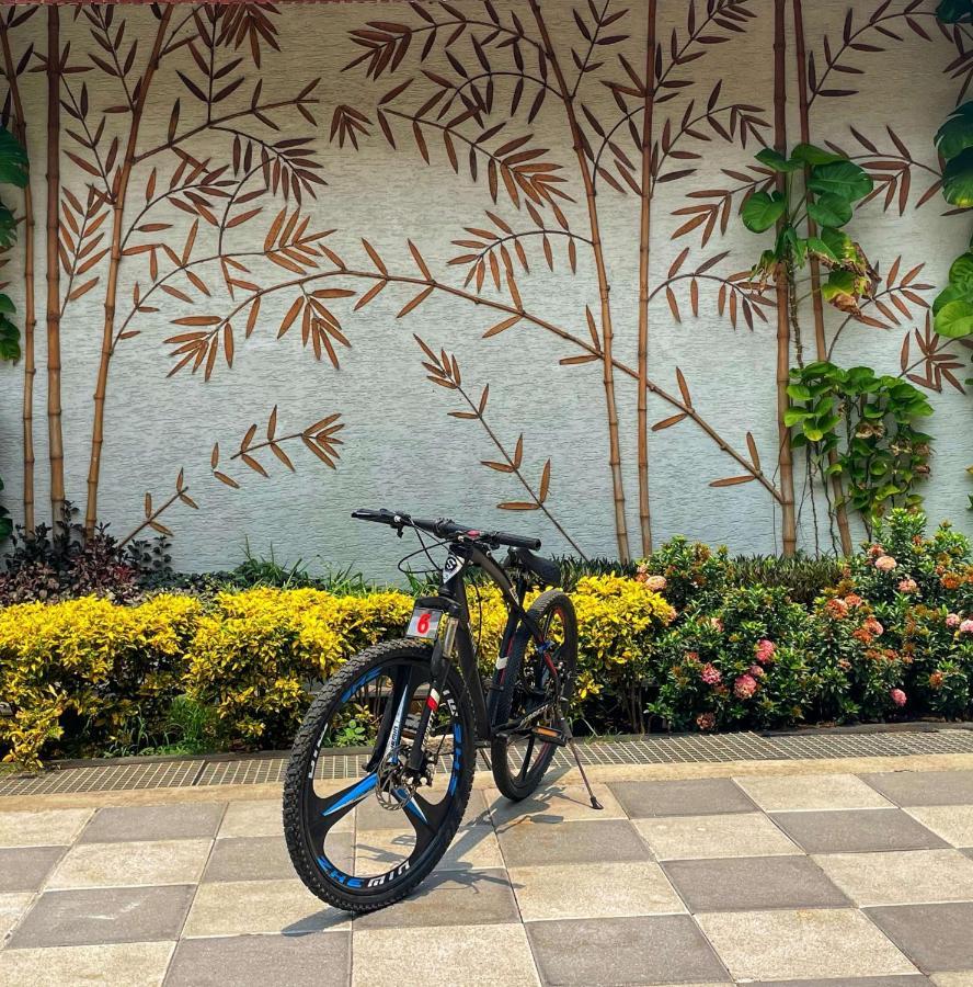 Radisson Blu Plaza Resort & Convention Centre Karjat Exteriör bild A bicycle parked in front of a wall with a bamboo design