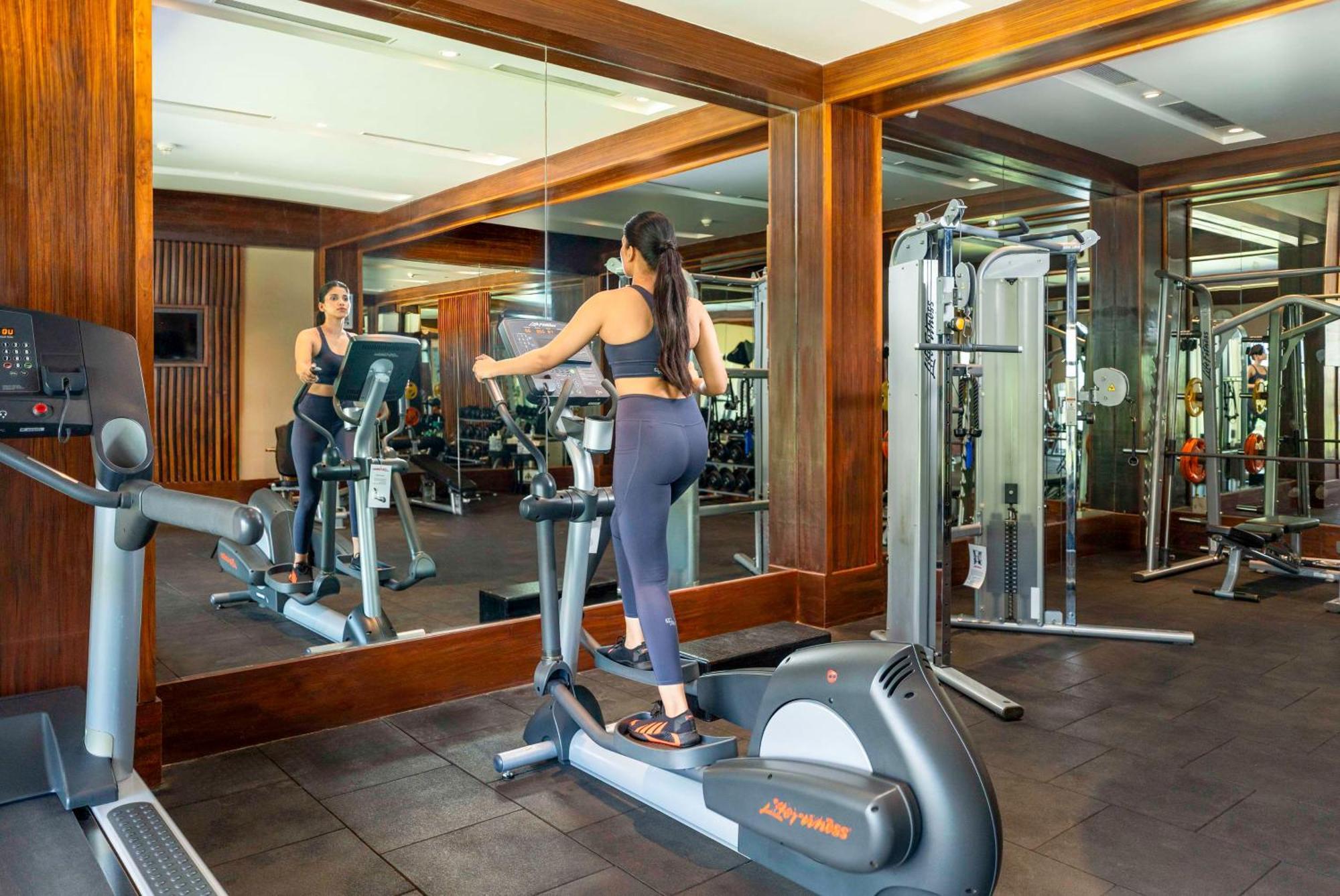 Radisson Blu Plaza Resort & Convention Centre Karjat Exteriör bild A woman on an elliptical trainer